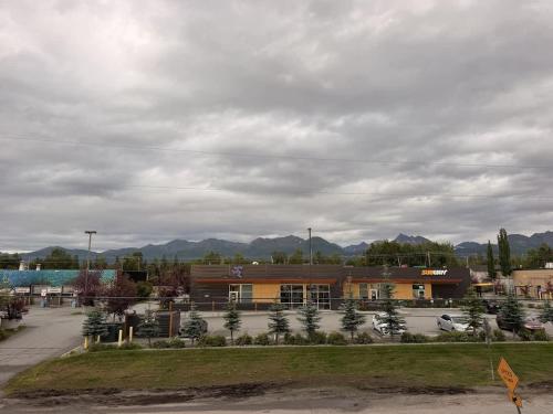 a large building with a parking lot in front of it at New Modern 2 Bedroom Apartment in Anchorage