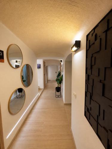 a hallway in a house with mirrors on the wall at Urban Base CELJE in Celje