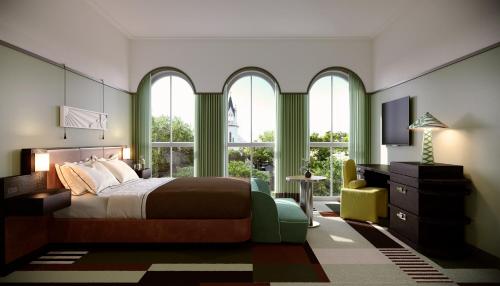 a bedroom with a bed and two windows and a television at The Warbler in New Orleans