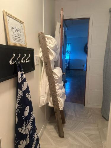 a room with a towel rack and a pile of towels at Waterfront Retreat in Slidell