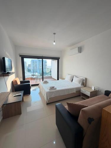 a large bedroom with a bed and a couch at Caesar Resort & SPA - Apartments Studio in Iskele