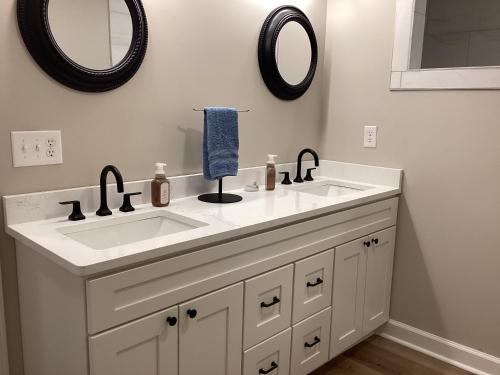 a bathroom with a white sink and two mirrors at Pickwick Dreams in Counce