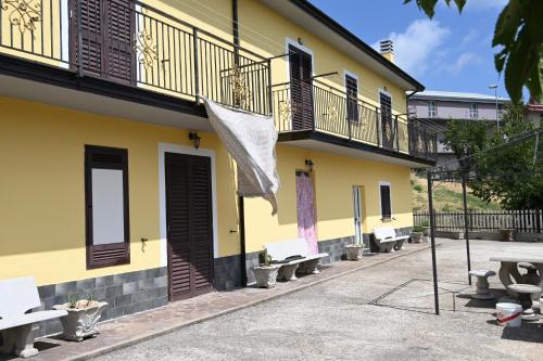 a row of benches in front of a building at Casa Experience - Acri in Calamia