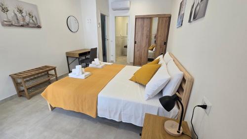 a bedroom with a large bed and a lamp at Dimora Clorinda 2 in Passo Corese