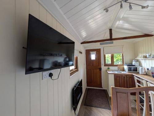 a small kitchen with a tv on the wall at The Willows in Scarisbrick