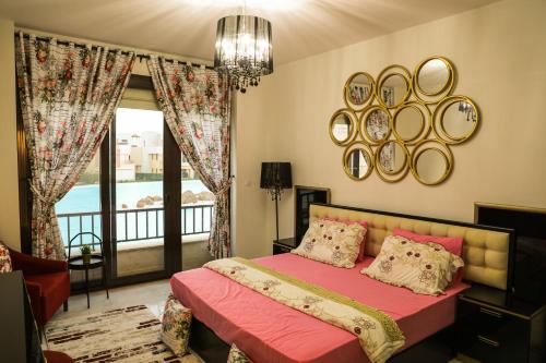 a bedroom with a bed and a large window at Luxury Marassi Villa on Lagoon in El Alamein