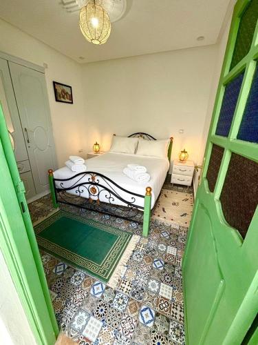 a bedroom with a bed and a chandelier at Marrakech Premium Dar Aicha in El Gouassem