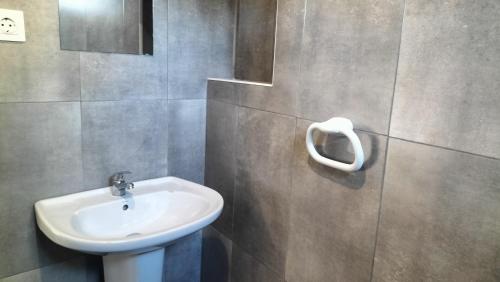 a bathroom with a sink and a toilet at AL - Bino - T3 in Carregosa
