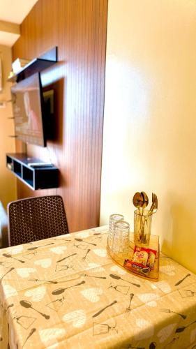 a table with a table cloth on it with a bowl on it at Avida Condo Lux Studio Unit in Iloilo City