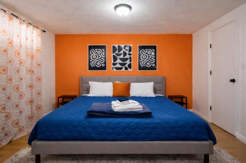 a bedroom with a blue bed with orange walls at Adventure's Oasis, Venture Base Unit 4 in Kanab