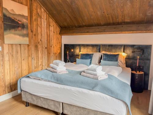 a bedroom with a large bed with towels on it at Gerlitzen Seealm in Afritz