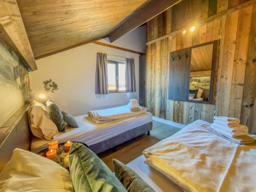 a room with two beds and a mirror at am Afritzer See in Afritz