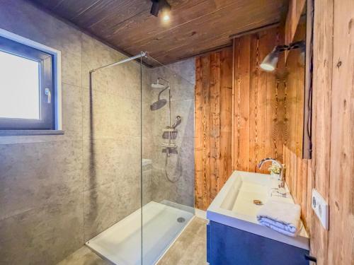 a bathroom with a glass shower and a sink at am Afritzer See in Afritz