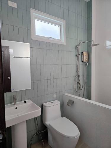 a bathroom with a toilet and a sink and a shower at Tasowa House in Chiang Rai