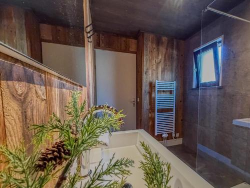 a bathroom with a tub and a glass shower at Alpenchalet am See in Afritz