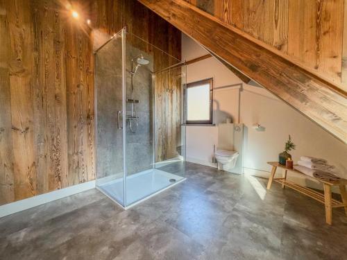 a bathroom with a glass shower with a toilet at Afritz am See in Afritz