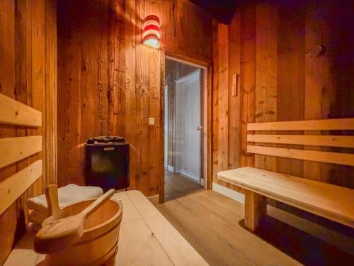 a wooden room with a bench and a trash can at Verditzblick in Afritz