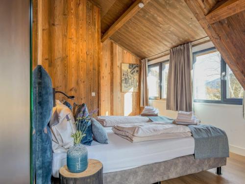 two beds in a room with wooden walls at Afritz am See in Afritz