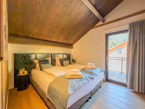 a bedroom with a large bed with towels on it at Seechalet Afritz in Afritz