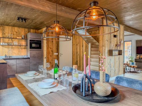 a dining room with a table with wine glasses at Alpenchalet Afritz am See in Afritz