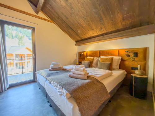 a bedroom with a large bed with towels on it at Mirnockblick in Afritz