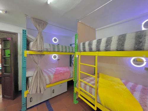 a room with two bunk beds in a room at Prisma Hostel in Bogotá