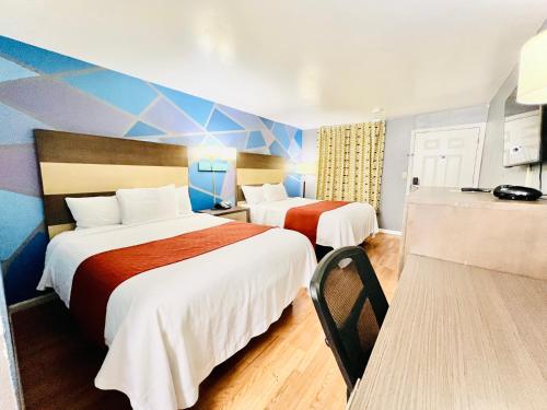 a hotel room with two beds in a room at Hometown INN in Berea