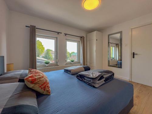a bedroom with a large bed with two pillows on it at Zicht op Valkenburg in Schin op Geul