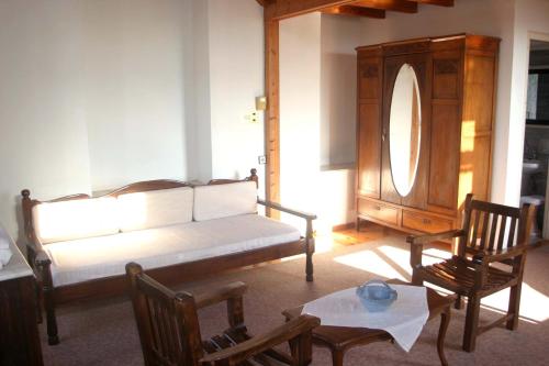 a living room with a couch and a table and chairs at Oasis Guesthouse in Chania Town
