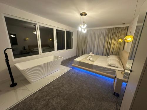 a bathroom with a bath tub and a bed and a bath tub at Casa DAIANA in Moisei
