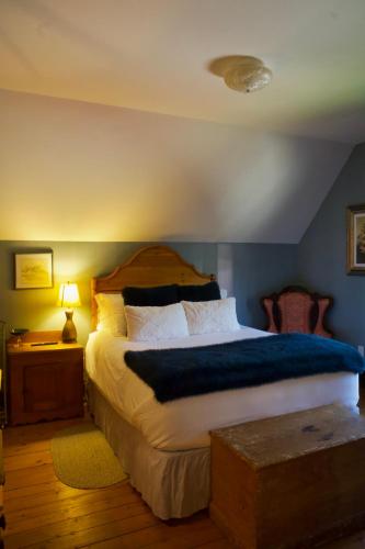 a bedroom with a large bed with a blue wall at Magnetic Hill Winery in Moncton