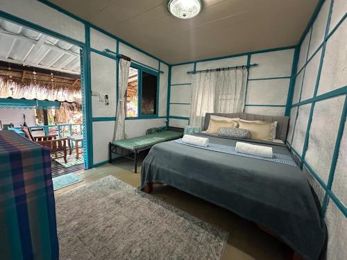a bedroom with a bed in a room with a window at Benny sweet family in Ao Phutsa