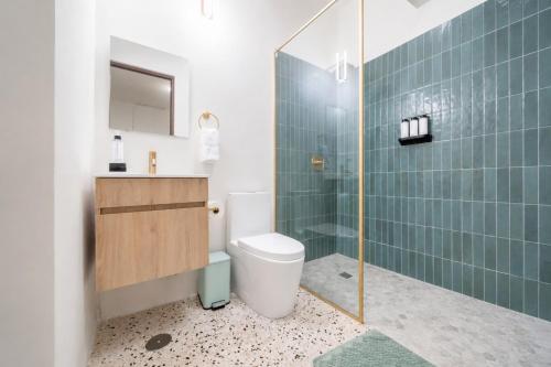 a bathroom with a toilet and a glass shower at Room 14: Chill City Veranda Near Miramar in San Juan