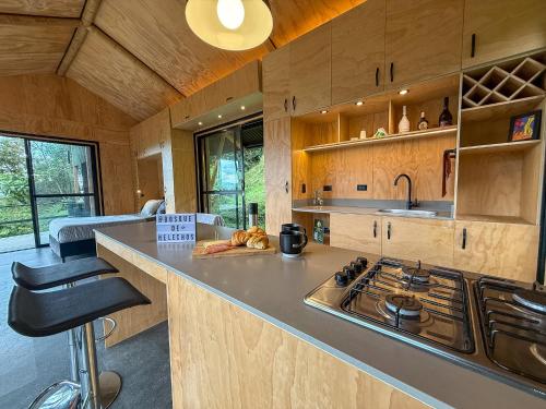a kitchen with a stove and a counter top at Glamping Bosque de helechos, privacidad y cercanía in Manizales
