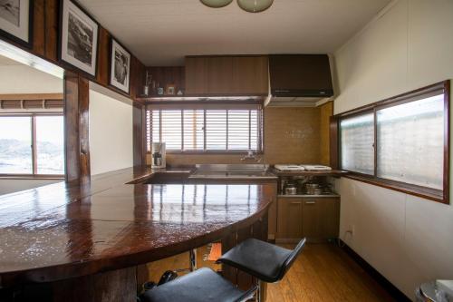 a kitchen with a large counter top in a room at Saka no Kaze in Onomichi