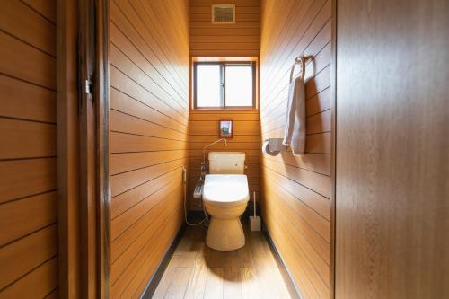 a small bathroom with a toilet and a window at Saka no Kaze in Onomichi