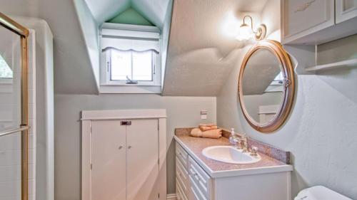 a bathroom with a sink and a mirror at Hustons Attic by AvantStay in Paso Robles