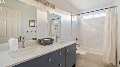 a white bathroom with a sink and a toilet at Summer Place by AvantStay in Templeton