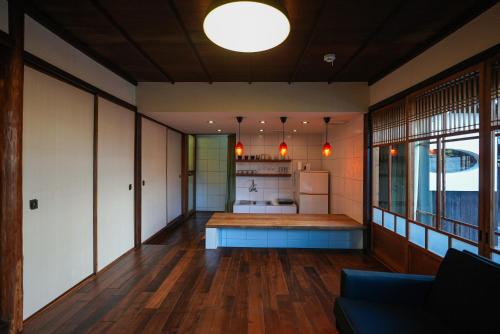 a room with a kitchen and a living room at Moon's Cafe in Onomichi