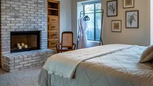 a bedroom with a brick fireplace and a bed at Na Hoku Ranch by AvantStay in Atascadero