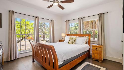 a bedroom with a bed and two windows at Chateau Paso by AvantStay in Paso Robles