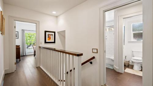 a white hallway with a toilet and a staircase at Chateau Paso by AvantStay in Paso Robles