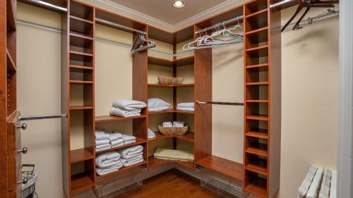 a walk in closet with wooden shelves and towels at 13th Street Retreat by AvantStay in Paso Robles