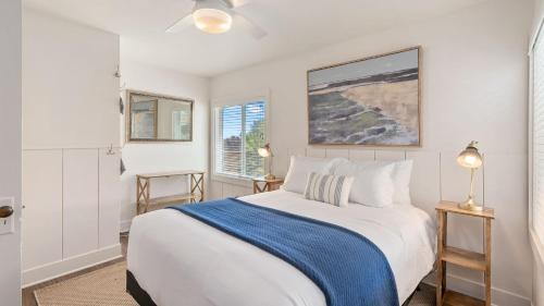 a white bedroom with a bed and two windows at 7th Street Sanctuary by AvantStay in Paso Robles