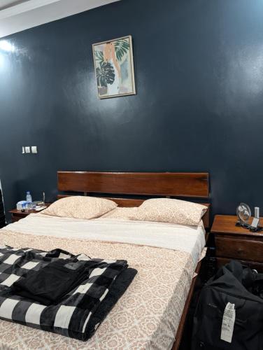 a bedroom with two beds and a blue wall at Tam-Toboyah in Conakry