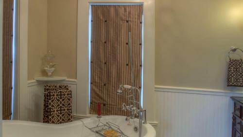 a bathroom with a bath tub and a shower at Bliss House by AvantStay in Paso Robles