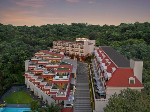 an aerial view of a resort building with a pool at Grand Mercure Goa Candolim - An Accor Hotels Brand in Candolim