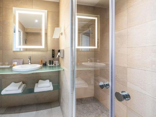 a bathroom with a shower and a sink at Ibis Styles Lyon Gorge de Loup Saphir in Lyon