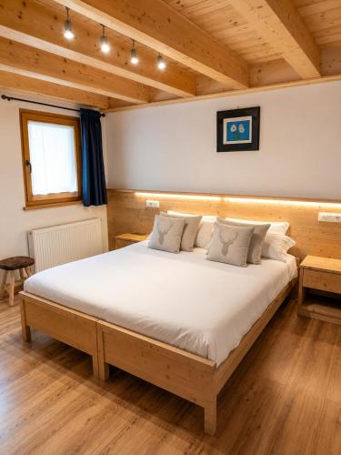 a bedroom with a large bed in a room at Chalet - Margherita in Sappada