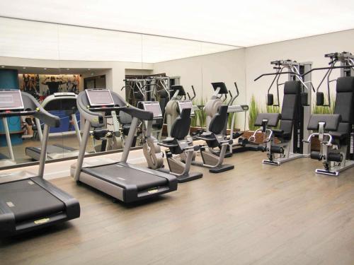 a gym with several treadmills and elliptical machines at Mercure Orléans Centre Bords de Loire in Orléans